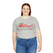 A woman wearing a grey iHeartFruitBox Fitted Unisex T-Shirt by Printify, promoting Tropical Fruit.