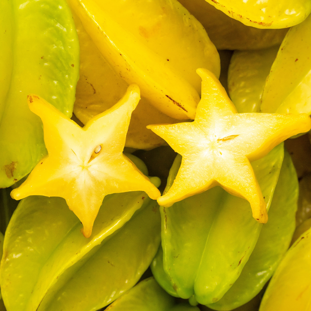A Star Fruit (Carambola) cut in half is showcased in the iHeartFruitBox.