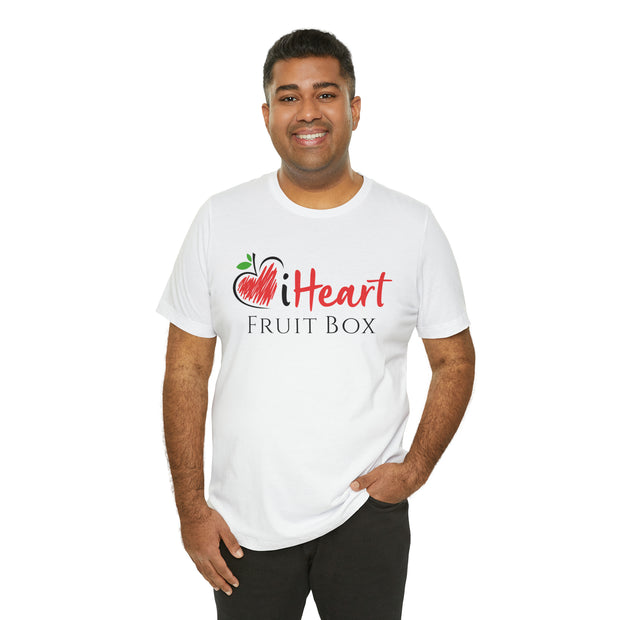 A man in a Printify iHeartFruitBox Fitted Unisex T-Shirt holding a tropical fruit.