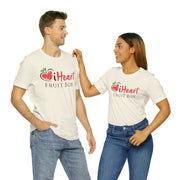 A man and woman standing next to each other wearing a iHeartFruitBox Fitted Unisex T-Shirt by Printify, promoting the iHeartFruitBox subscription service.