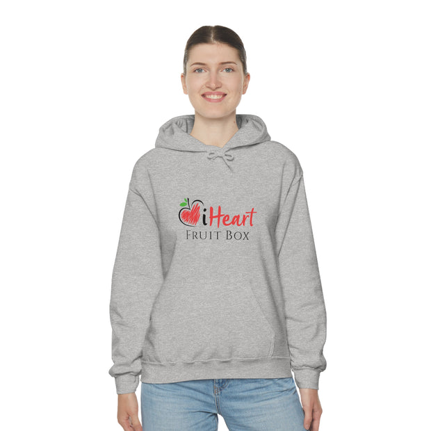 A woman wearing a grey iHeartFruitBox Unisex Heavy Blend™ Hoodie from Printify, showcasing her love for organically grown tropical fruit.