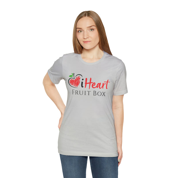 A woman wearing a grey iHeartFruitBox Fitted Unisex T-Shirt from Printify, promoting organically grown tropical fruit.