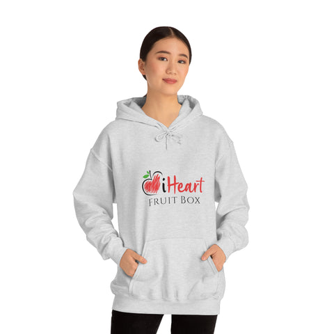 A woman wearing a grey hoodie, the iHeartFruitBox Unisex Heavy Blend™ Hoodie by Printify, with the word fruit on it, showcasing her love for organically grown tropical fruit.