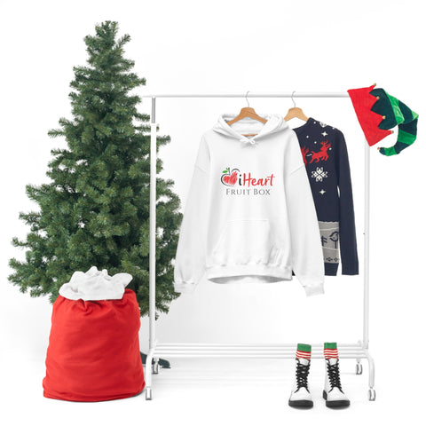 Santa hats, sweaters, and a christmas tree on a clothes rack adorned with festive Printify iHeartFruitBox Unisex Heavy Blend™ Hoodie ornaments.