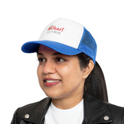 A woman wearing a blue and white trucker hat and holding a Printify iHeartFruitBox Branded Mesh Cap.