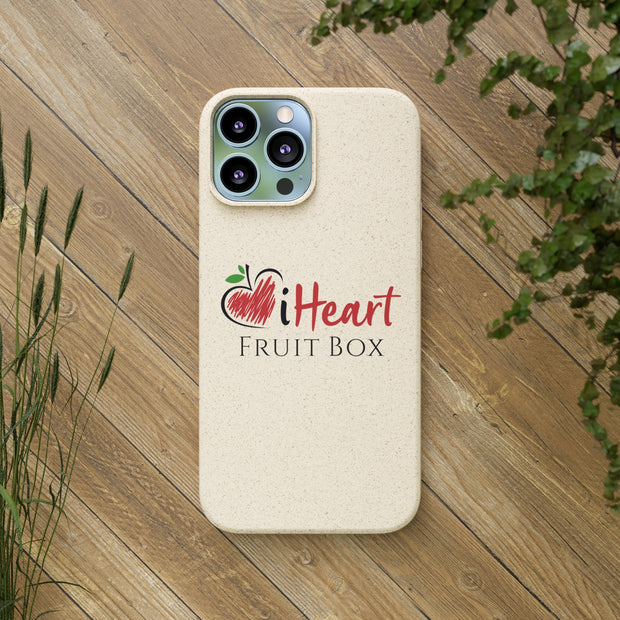 A iHeartFruitBox Biodegradable Phone Case with a heart on it and a tree in the background, featuring organically grown tropical fruits, produced by Printify.