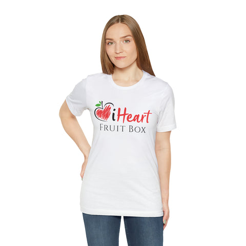 A woman wearing a white shirt enjoying tropical fruit from her Printify iHeartFruitBox Fitted Unisex T-Shirts.