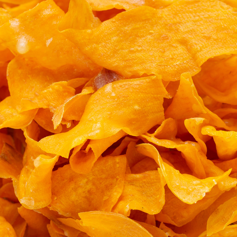 A close up of a pile of dried mango chips from the iHeartFruitBox.
