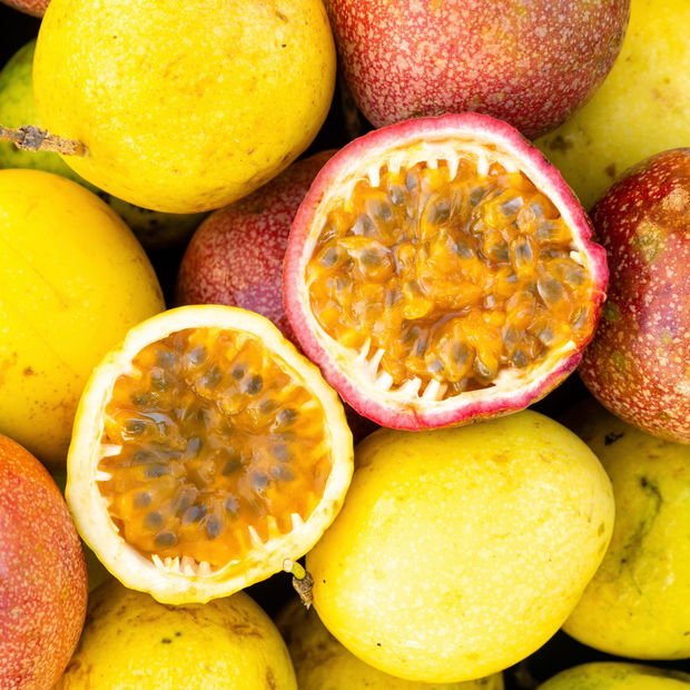 A close up of a pile of iHeartFruitBox's organically grown Passion Fruit (Maracuya)***Pre Order***.