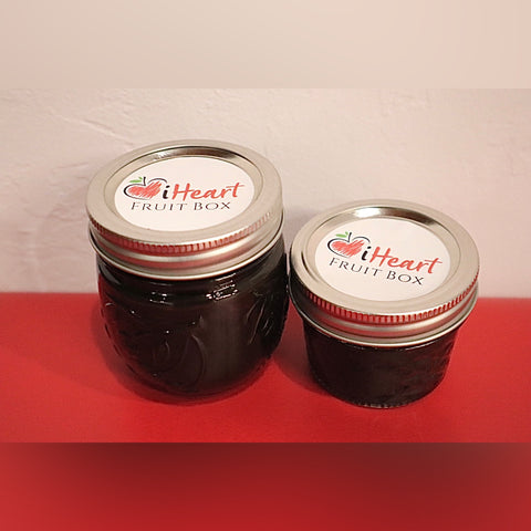 Two jars of iHeartFruitBox Black Sapote Chocolate Raspberry Jam next to each other.